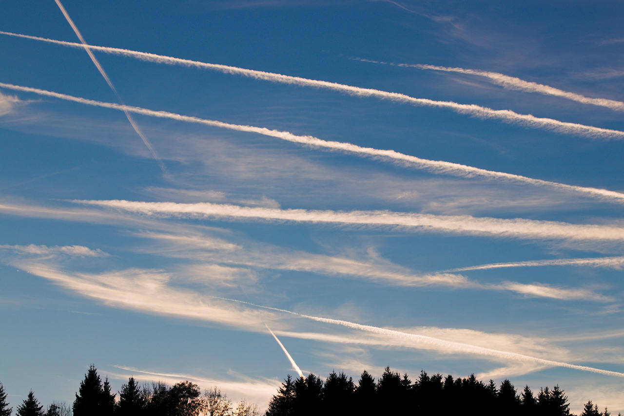 Klimakrise - Flugscham oder Zugstolz: Himmel mit zahllosen Kondensstreifen